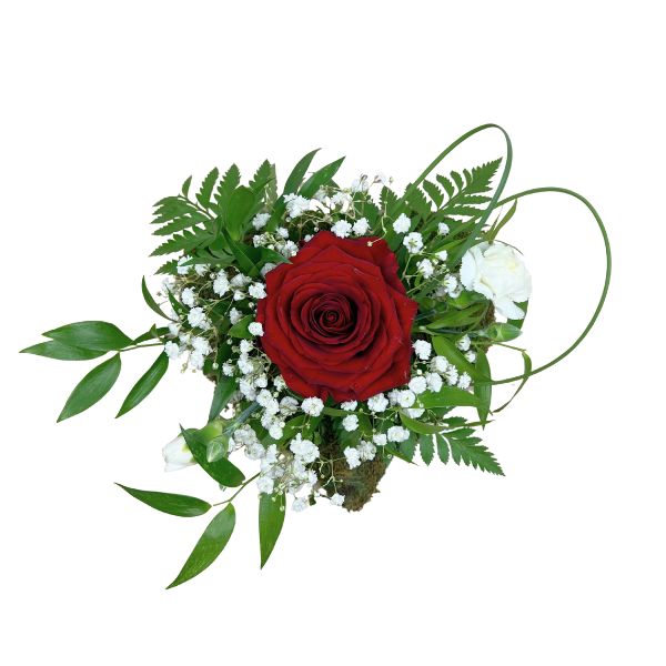 Gravsmyckning med dekorativa blommor och grönska