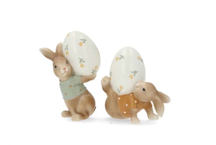 Påskdekoration med två kaniner som håller målade ägg